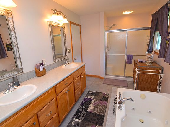 Spacious bathroom has everything you could want including jacuzzi tub and shower.