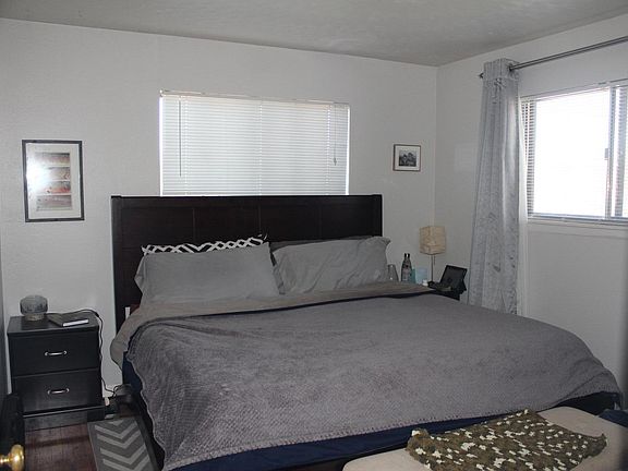 King sized bed is pictured, an end table on each side with room to spare, and 4.5 feet from the end of the bed to the wall. This room is This room is 11'7" X 10'9"