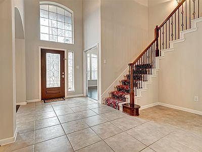Entryway with first set of stairs