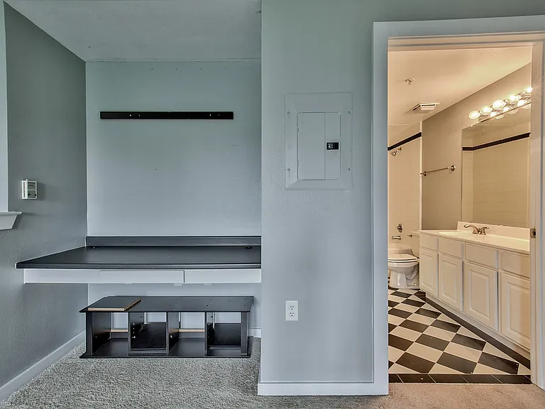Built-in desk area with a dark countertop and light grey walls