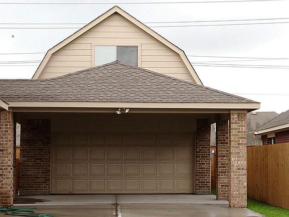The porte cochere is a great place for additional covered parking or to barbeque out of the Texas su