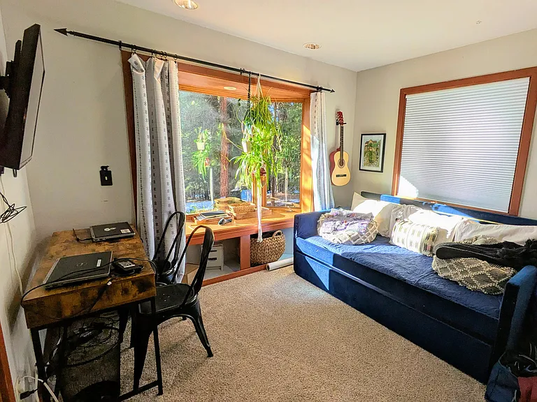 4th bedroom is also downstairs and offers desk space, a trundle bed, closet, and sunny bay window + second window