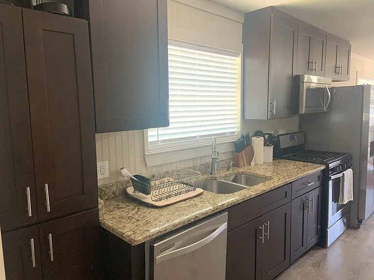 Granite counter top, SS dishwasher, gas range, microwave and refrigerator.