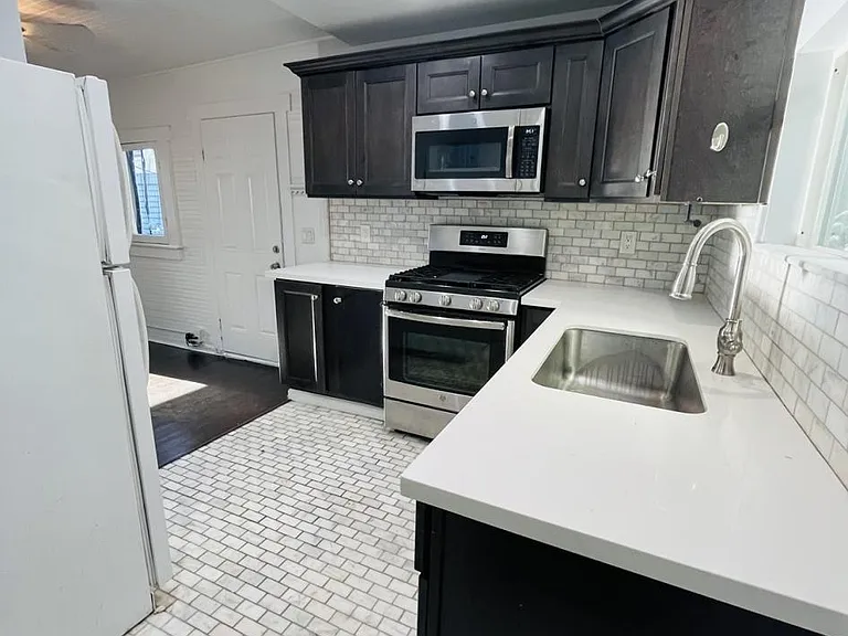 Kitchen space, viewing from bathroom barn-door location.