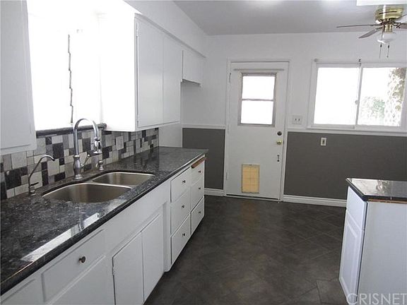 Granite counter tops and stone mosaic backsplash.