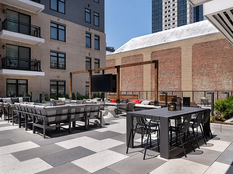 Outdoor rooftop lounge with firepits, grilling & outdoor dining space.