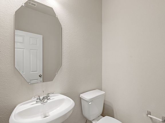 This charming home features a beautifully appointed half bath adjacent to the family room, perfect f