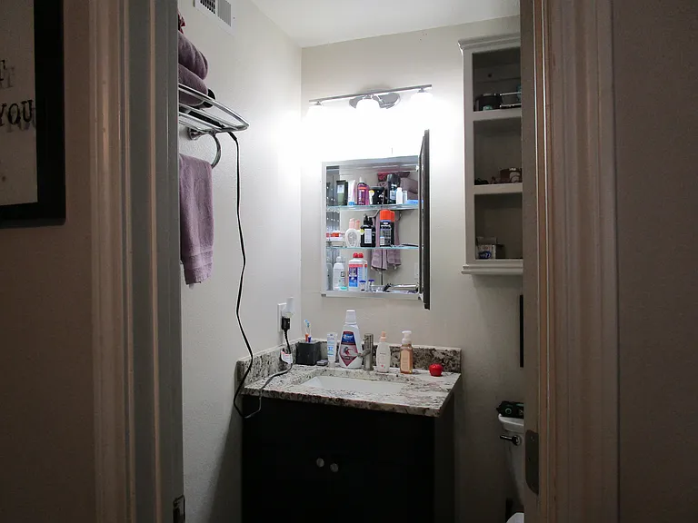Rear bedroom bath sink and medicine cabinet.