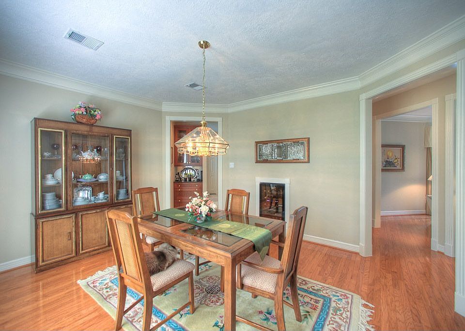 Another view of formal dining room with plantation shutters and beautiful trim