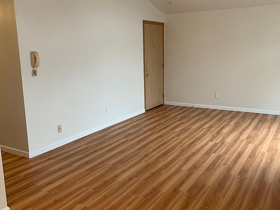 Living room and front door .

Wall intercom phone is gone .