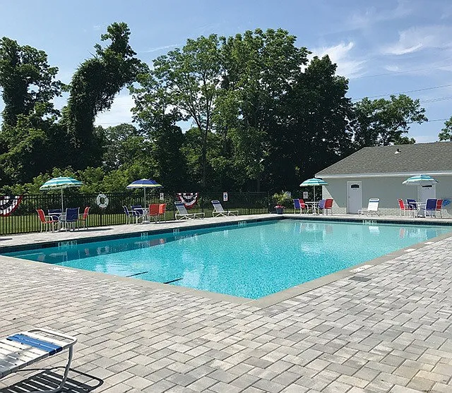 Enjoy a refreshing escape at Atlantic Manor Apartments, featuring a sparkling pool surrounded by lush landscaping and ample lounge space. Relaxation awaits just steps from your door. Schedule your visit today to explore your new home!