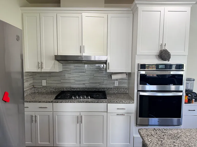 Upgraded chef kitchen with stainless steel appliances from whirlpool. Cooktop, chimney, microwave, oven, dishwasher and refrigerator.
Kitchen island with stainless steel large sink.