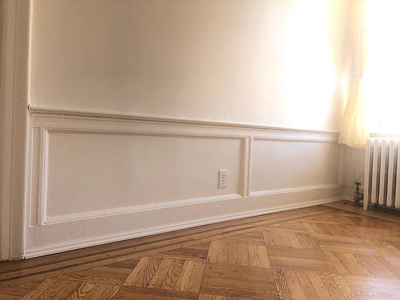 Living Room. Freshly painted. Retro Moldings and newly refinished All wood Floors.
