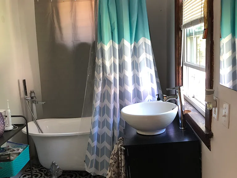 Bathroom on 1st floor, luxurious clawfoot bath tub and floating sink.