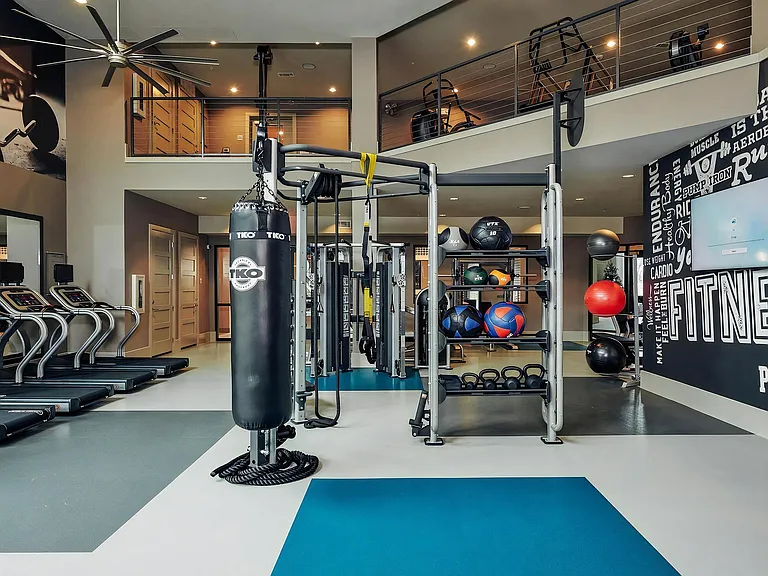 Two-Story Fitness Center with Treadmills, Boxing Bag, and Training Stations