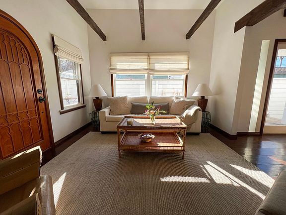 Front room has wood beams, hardwood floors and high ceilings.