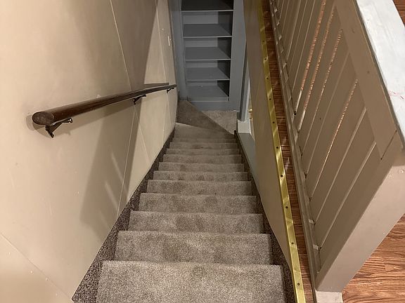 recently carpeted/ stairway to second floor from the kitchen.