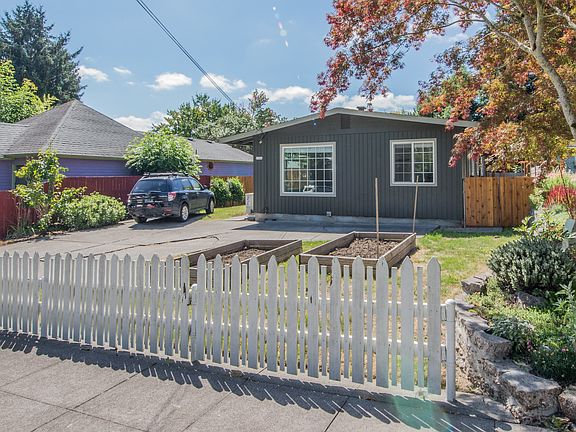 Residence with yard and garden beds