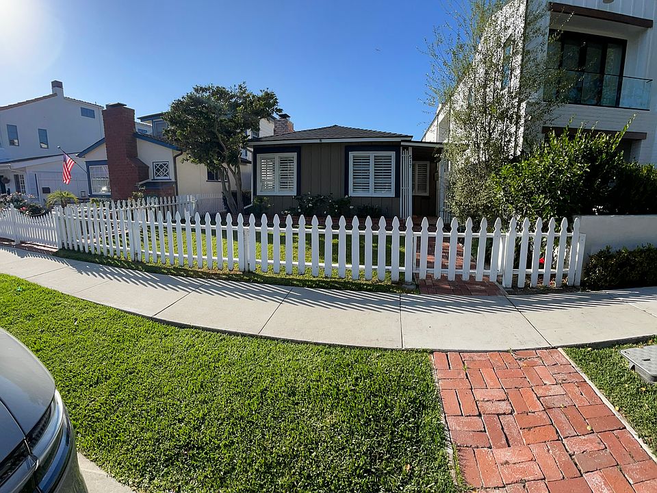 View from Carnation Ave, grassy front yard and picket fence.
