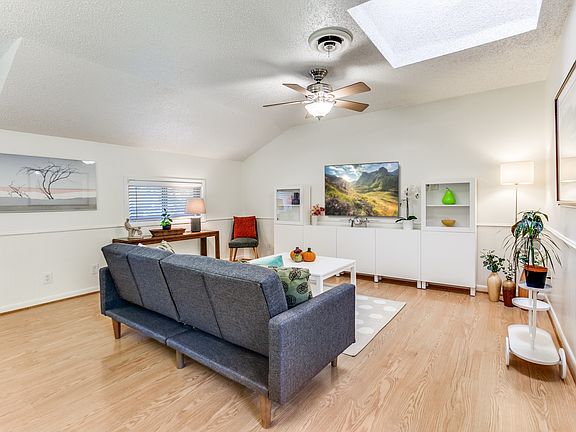Family room - featuring skylight, ceiling fan, smart TV with internet connection, and a futon sofa