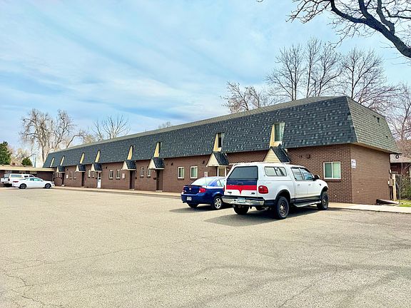 Charming townhouse complex with modern architectural design, ample parking, and serene surroundings.