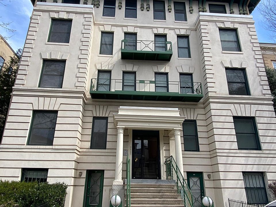 Front of building. Apartment has its own entrance to left of stairs.