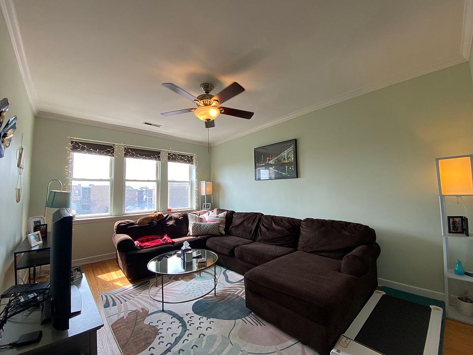 Living room with ample space, lots of natural light, higher ceilings, crown moulding, and fan (previous listing)