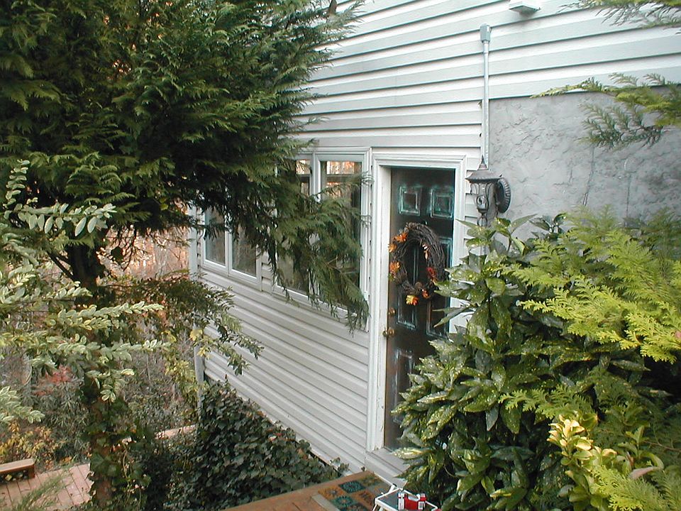 This is one of the 2 entrances to the apartment . You reach a landing on the side of the house to enter the apartment