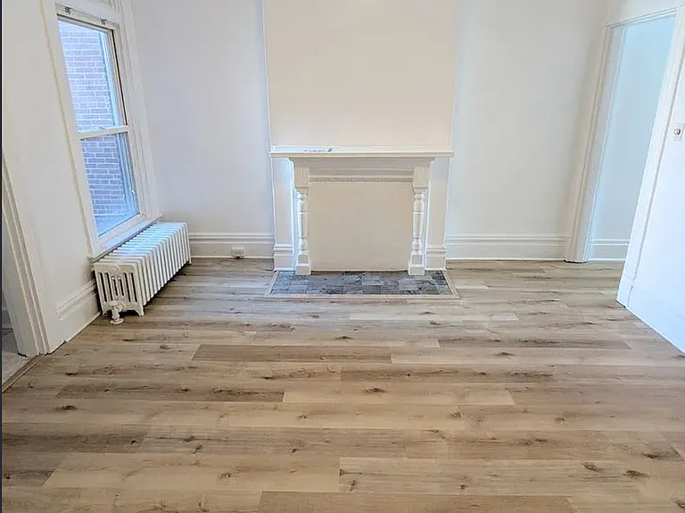 1st Floor Dining Room w/ natural stone hearth & fireplace, the door to the right leads to the full, dry basement (inquire for photos of excellent basement for storage and washer/dryer area)