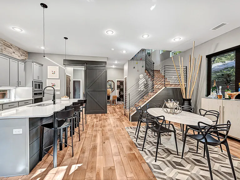 The front door is just past the 1/2 bath beyone the stairs. The laundry, pantry, garage access, and additional back door are off to the left behind the sliding barn door.