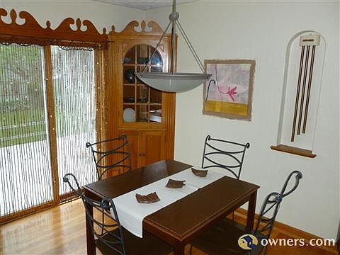 Dining room overlooking groomed back yard.