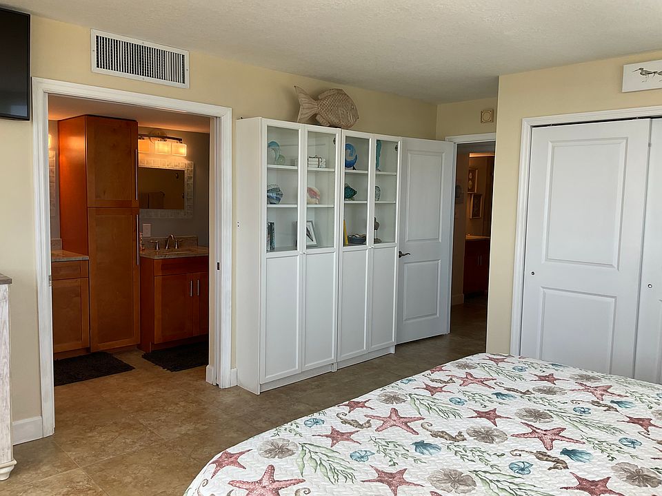 Master bedroom featuring walk-in closet, shower-bath tub combination with double sinks.