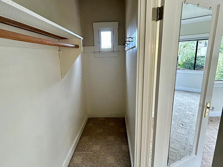 Interior of clothes closet
See little window at the back
Full length mirror on the back of the door