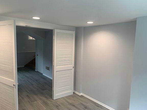 lower level bedroom / office area with privacy doors and recessed lighting