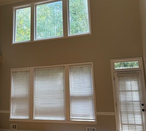 Spacious family room with view to the wooded backyard with running creek