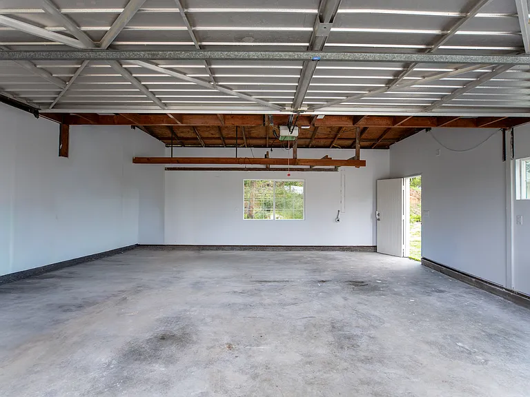 Protect your vehicles in this large 2 car insulated garage.