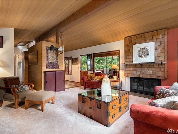 Wood-burning fireplace and vaulted cedar-lined ceilings; classic of the decade.