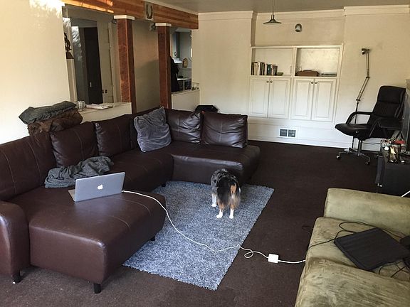 Flexible carpeted Living/ Dining area with built in rejuvenated cabinetry