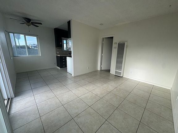 Living room into kitchen and door to bedroom