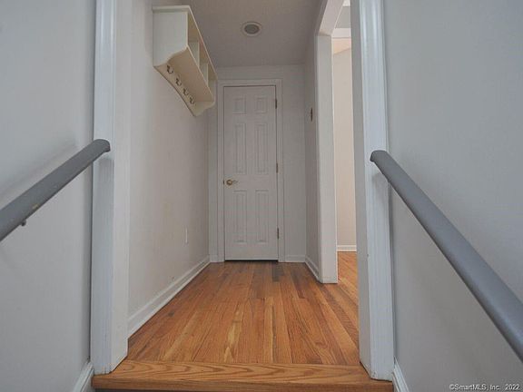 At the top of the stair landing there's a coat closet and wall mounted cubbies.