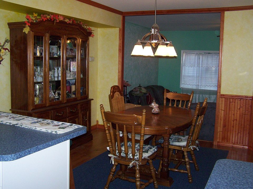 Updated dining room with wood laminate floors and custom crown molding.