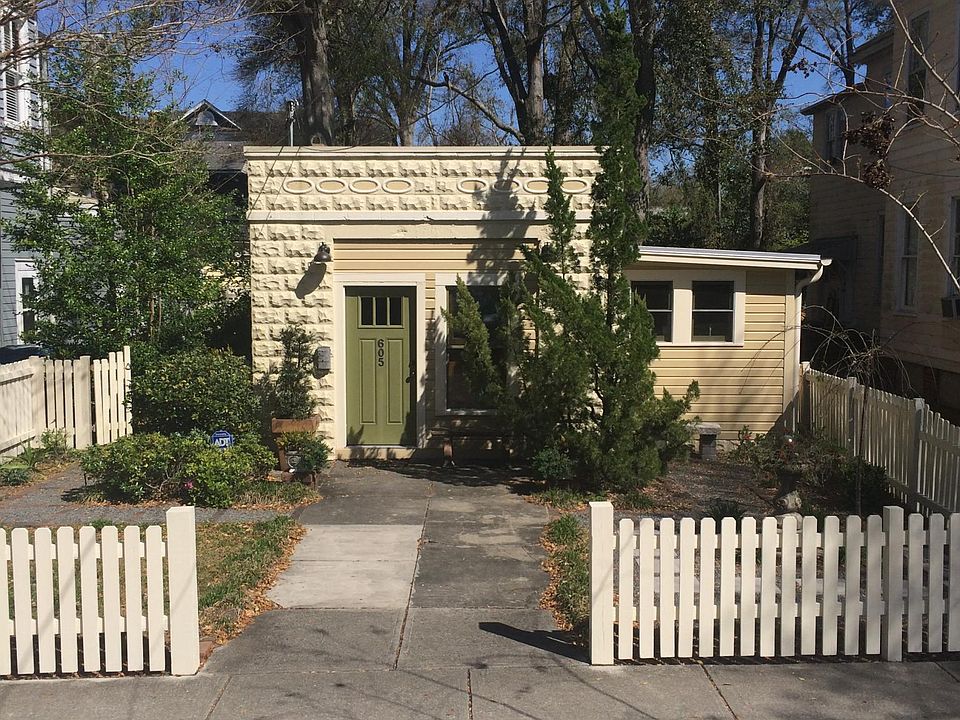 Street view with fenced front courtyard.