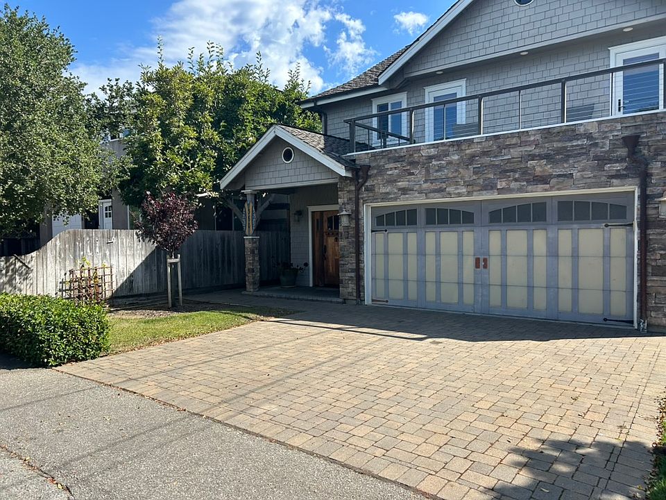 Front of house with front deck off of two guest bedrooms. Two car garage, EV ready.