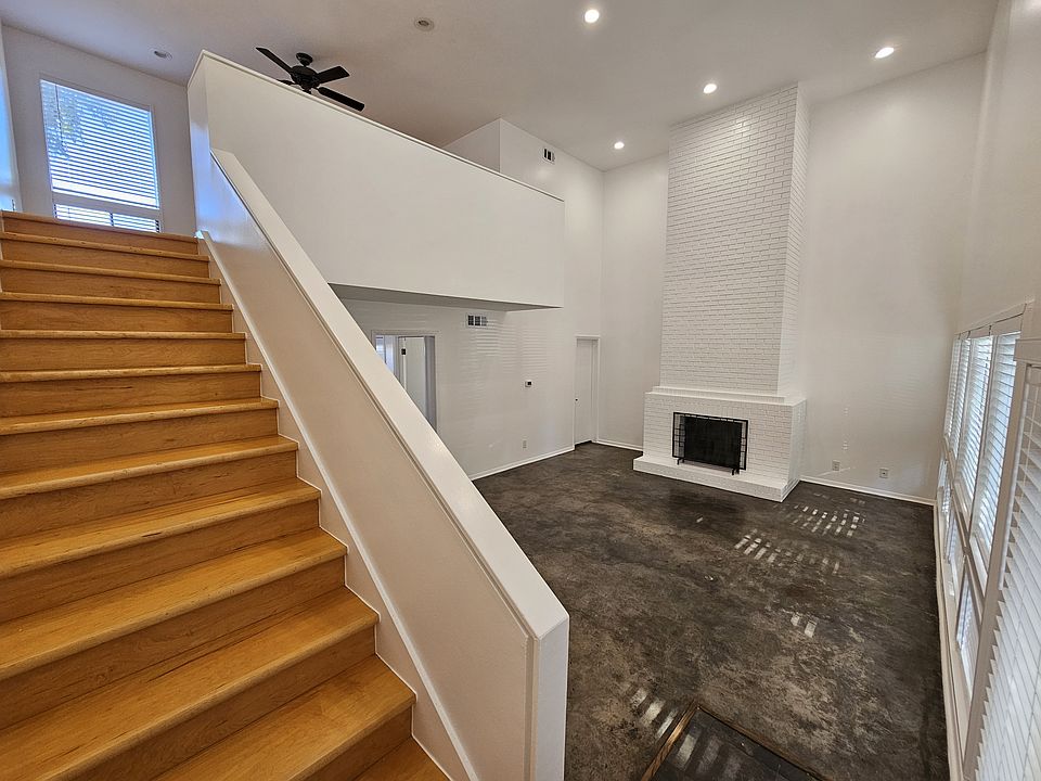 Inside the unit, view of living room and stairs to lofted primary