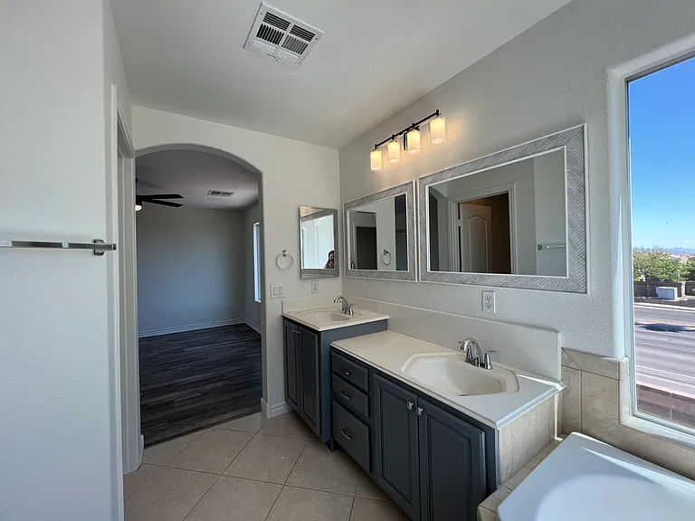 Alternate view of primary bath looking into bedroom.