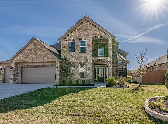 Amazing brick and stone elevation! Accompanied with nice landscaping.