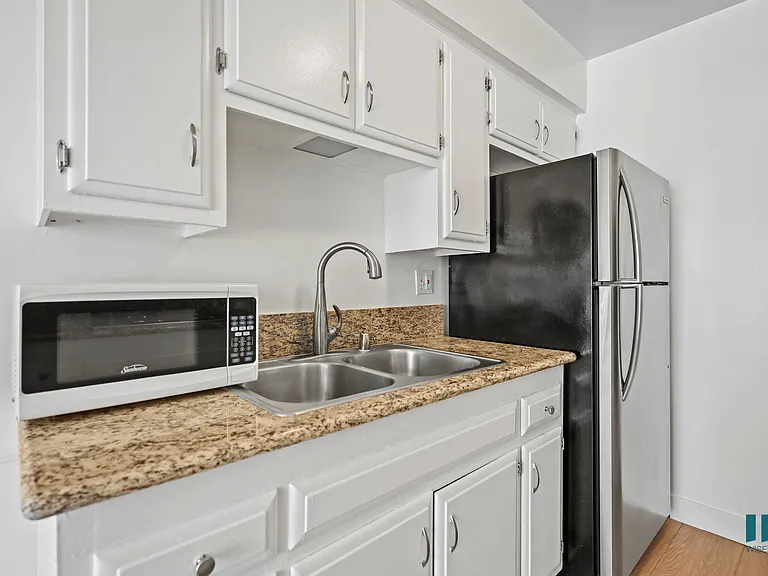 Kitchen with Refrigerator, Microwave, and Cabinet Storage