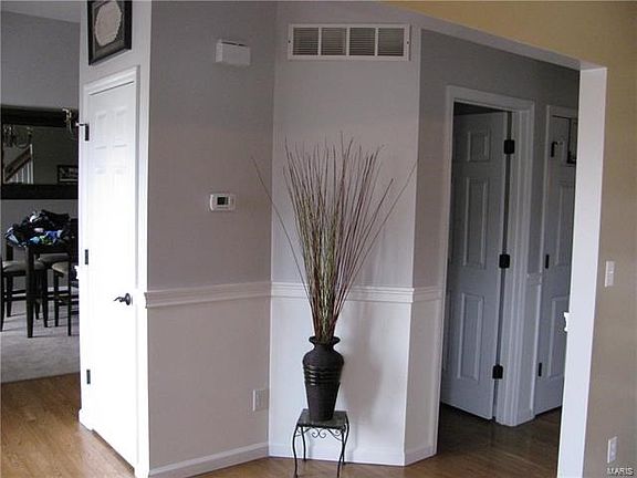 Front foyer, hallway with powder room.