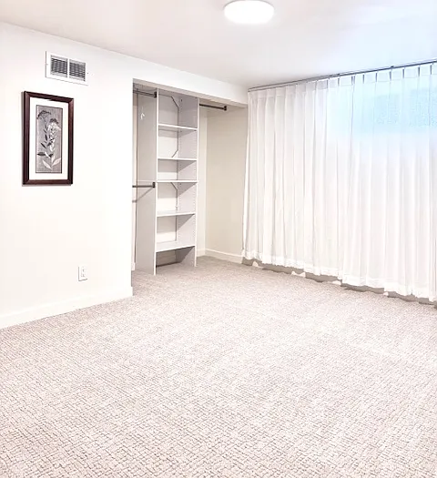 Bright and spacious room A, 180 sqft. with 2 wall art and a big closet. Window facing west street.
