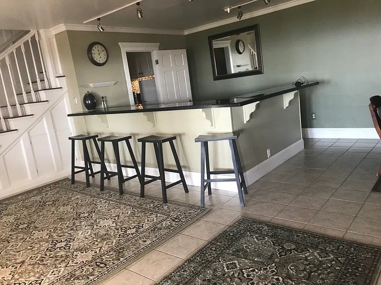 BAR SHOWING DOOR OPEN TO PANTRY/LAUNDRY